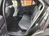 a black car with the door open and the seats down