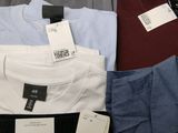 several men ' s shirts are stacked on top of each other in a box