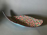 a close up of a bowl with a spoon on a table