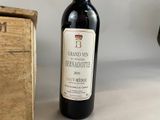 a bottle of wine sitting next to a wooden box
