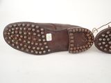 pair of brown leather shoes with studded soles on a white surface