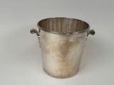 a silver bucket with handles on a white surface