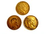 three gold coins with a picture of a man and a woman on them