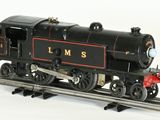 a black and red train on a track on a white background
