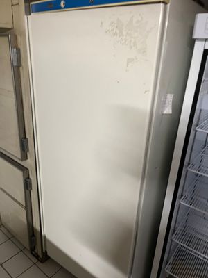 a white refrigerator in a kitchen next to a refrigerator freezer