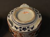 a small bowl with a lid sitting next to a smaller bowl