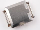 a metal object that is on a white surface