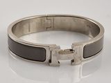 an image of a black and silver bracelet with a silver buckle