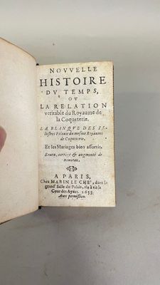 someone is holding a book in their hand and pointing at it
