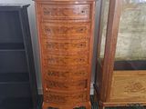 a tall wooden chest of drawers next to a tall wooden cabinet