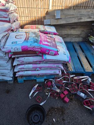 a pile of bags of dog food on a pallet
