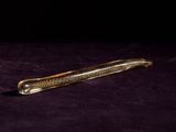 a knife that is laying on a purple cloth