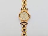an image of a close up of a wrist watch on a white surface