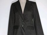 a black and white striped jacket on a mannequin dummy