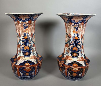 two vases are sitting side by side on a gray surface