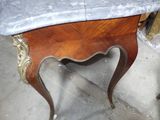 a marble top table with a wooden base and a marble top