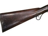 an old gun with a wooden barrel and a metal handle