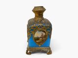 a blue and gold vase with a picture on it