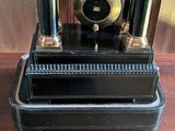 a clock that is sitting on top of a black case