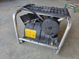 a small air compressor sitting on a cart in the garage