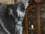 a statue of a man holding a sword in a room