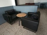 two chairs and a table in the corner of a room