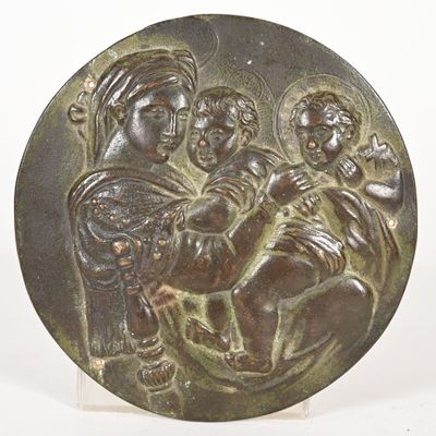 an image of a bronze plaque with a woman holding a child