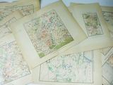 many maps on a table with a pair of scissors on it