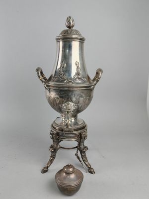 an antique silverplated coffee urn on stand with lid