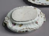 two plates with flowers on them on a table