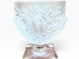 a white glass bowl with a silver base on a white background