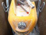 a yellow motorcycle that is in a box with a hose