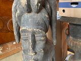 a statue of a man sitting on top of a box