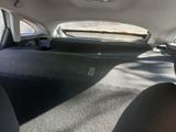 a view of the back seats of a car with the sun shining through the window