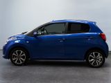 the small blue car is parked in a large room