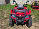 an image of a red four - wheeler atv parked in a yard