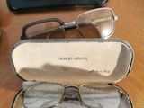 two glasses in a case on a table next to a pair of glasses