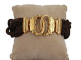 a close up of a pillow with a gold buckle on it