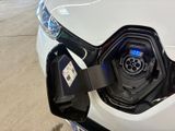 a close up of an electric car charging at a charging station