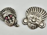 a pair of silver and pink stone indian head charms