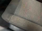 a close up of a seat in a car with a red stitching on it