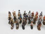 a lot of figurines that are on a white surface
