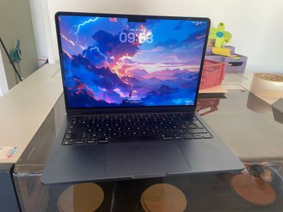 an open laptop computer sitting on top of a glass table