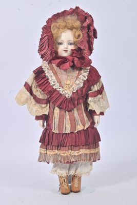 a doll that is wearing a red dress and hat