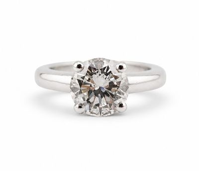 a close up of a diamond ring on a white background