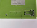 a green electronic device that is sitting on a table
