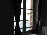 a radiator in front of a window in a dark room