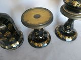 three black and gold vases sitting on a table