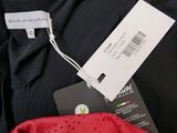 a close up of a black shirt with a tag on it