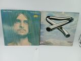 the two albums are sitting on a shelf next to a cell phone